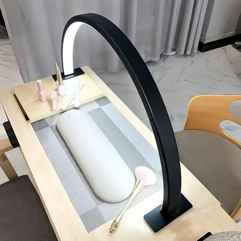 Black half moon lamp on a wooden beauty desk