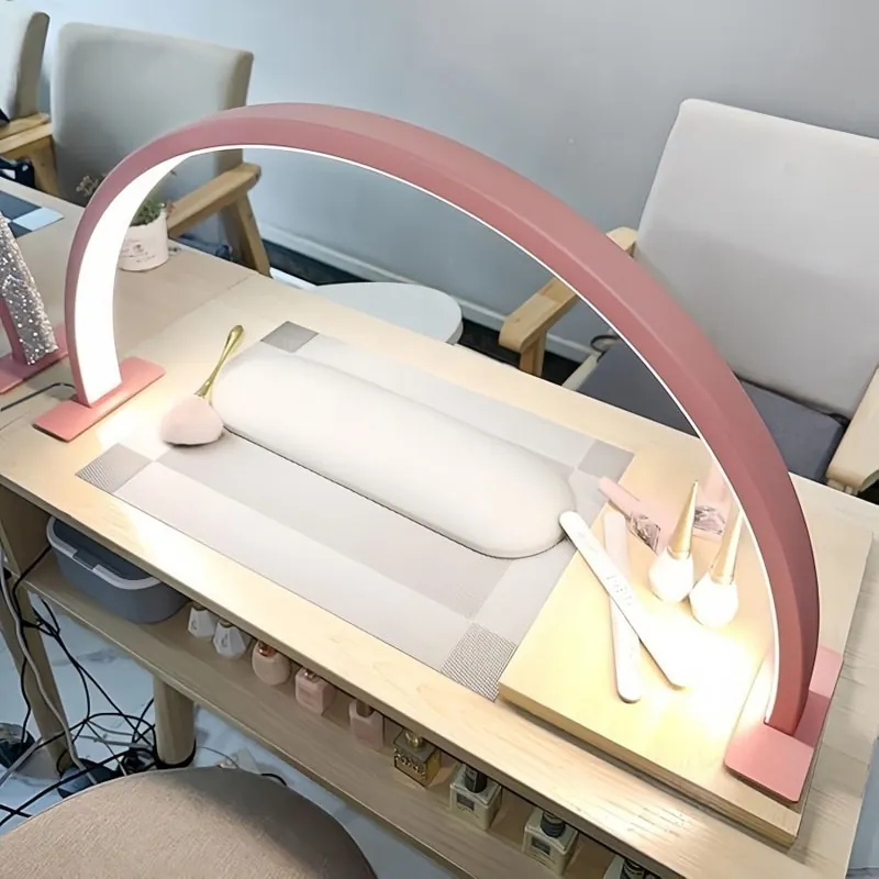Pink half moon lamp on a home nail desk